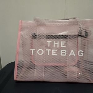 The tote bag pink. Plastic see through.